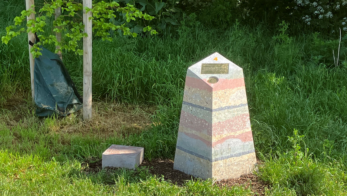 multi layered visual precast concrete way marker on wilderness path