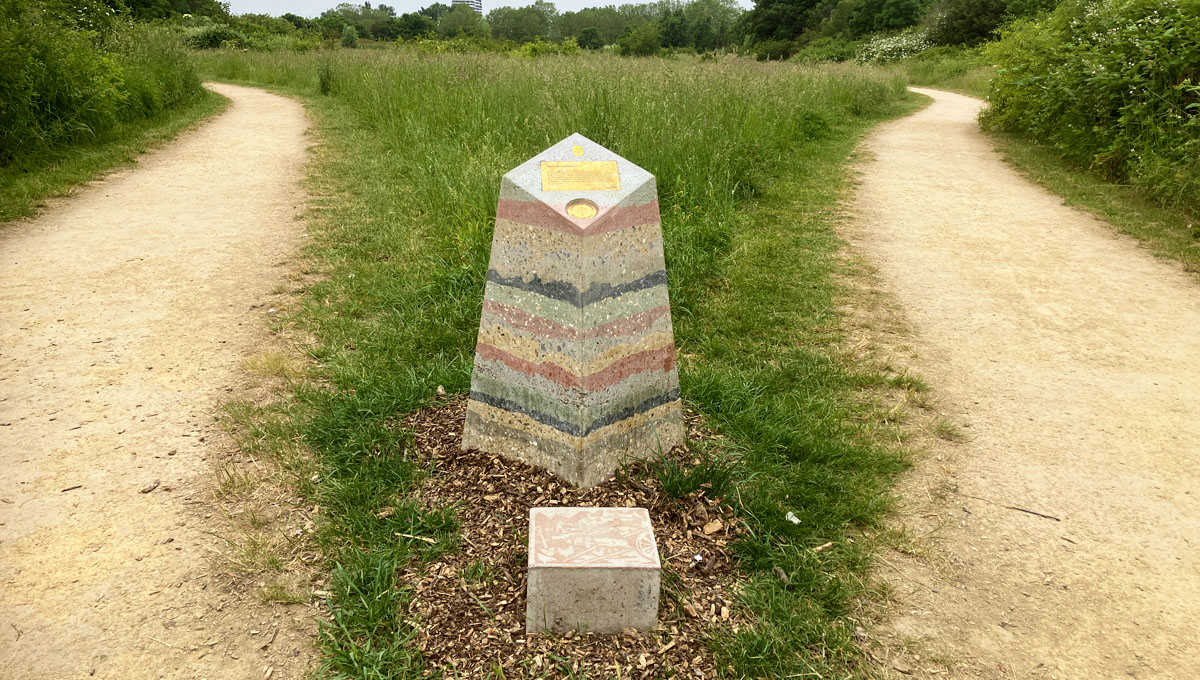 multi layered visual precast concrete way marker on wilderness path