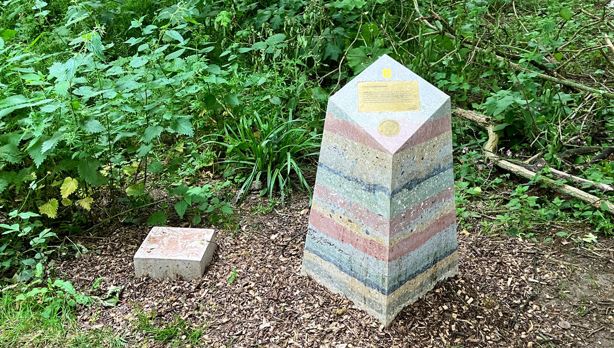 multi layered visual precast concrete way marker on wilderness path