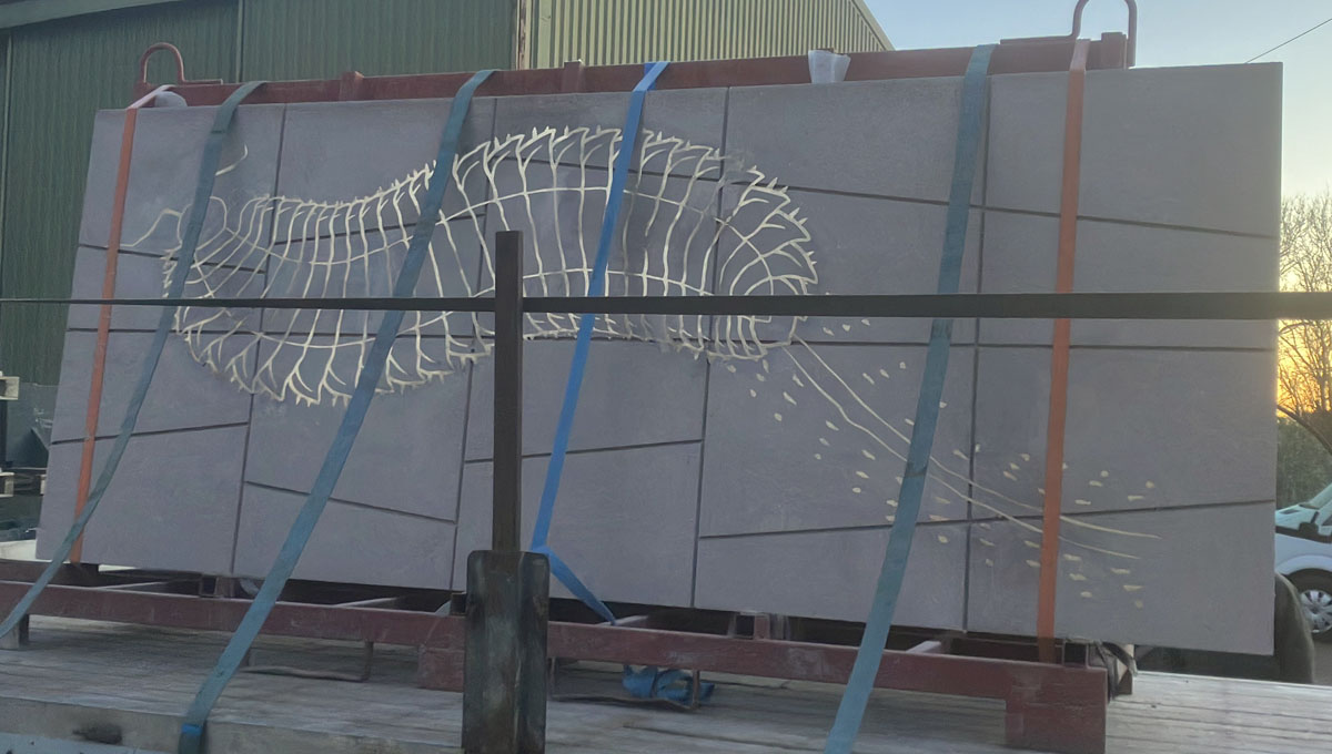 3.2 by 1.2m piece of visual precast concrete with paving slab pattern and a brass inlay of a prehistoric Millipede for the Natural history Museum, London