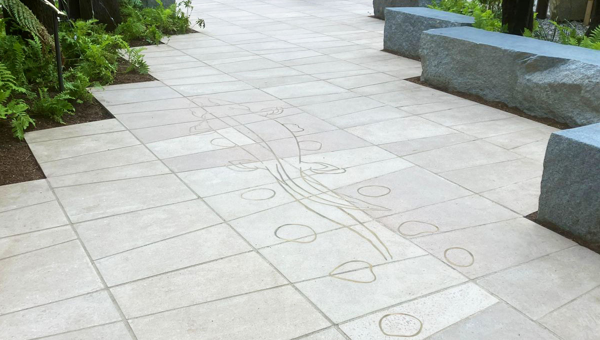 3.2 by 1.2m piece of visual precast concrete with paving slab pattern and a brass inlay of a prehistoric Taktaalik for the Natural history Museum, London