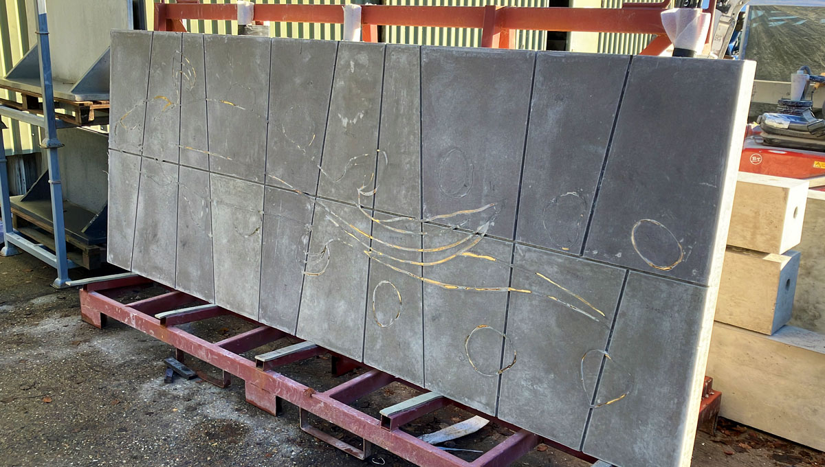 3.2 by 1.2m piece of visual precast concrete with paving slab pattern and a brass inlay of a prehistoric Taktaalik for the Natural history Museum, London
